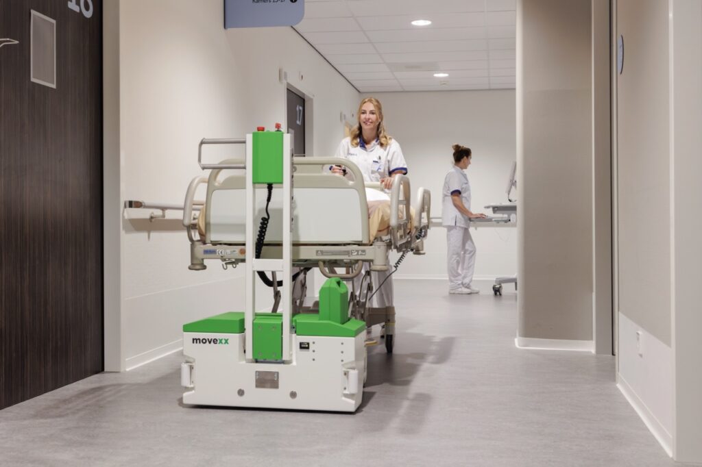 MOVEXX TT0450-M-BM bed mover turning a patient bed through a doorway at Amphia hospital