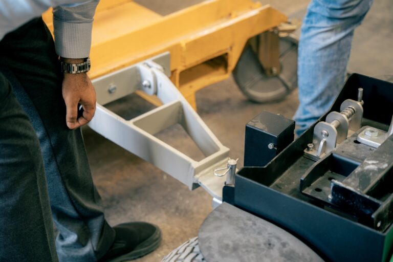 Close-up of the MOVEXX TT2500-S-AT tow coupling engaging the drawbar of a tipping skip
